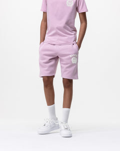 boy model wearing Rascal pink jogger smiley face shorts and pink smiley tee