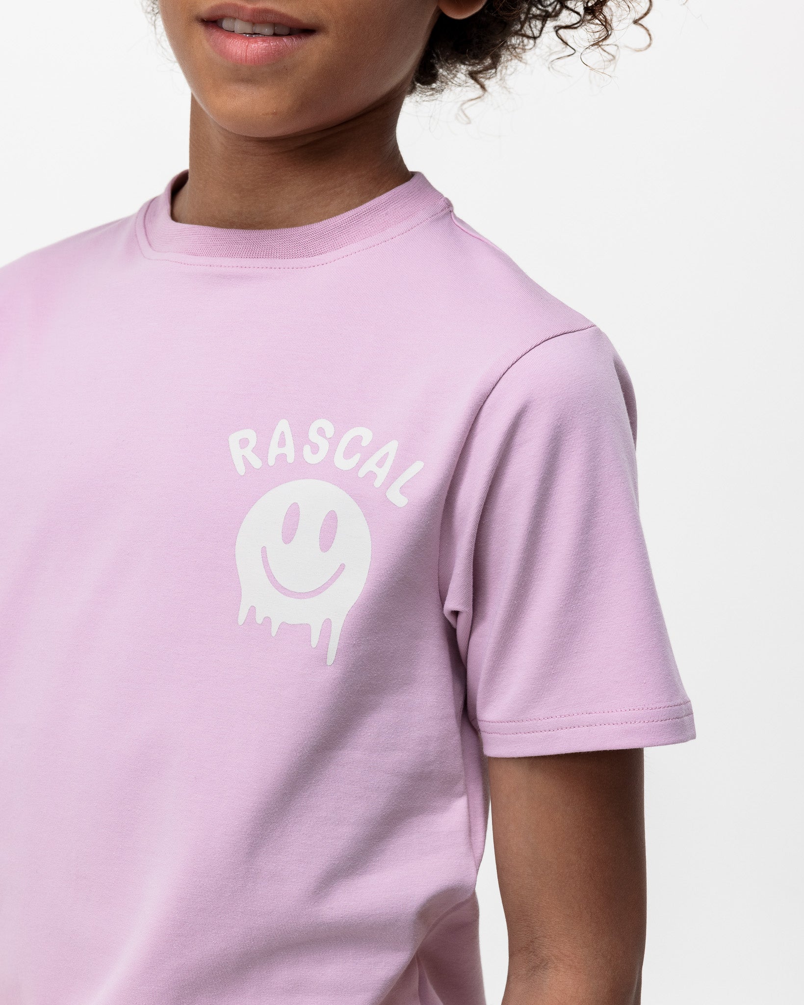 close up of boy wearing Rascal pink smiley tshirt