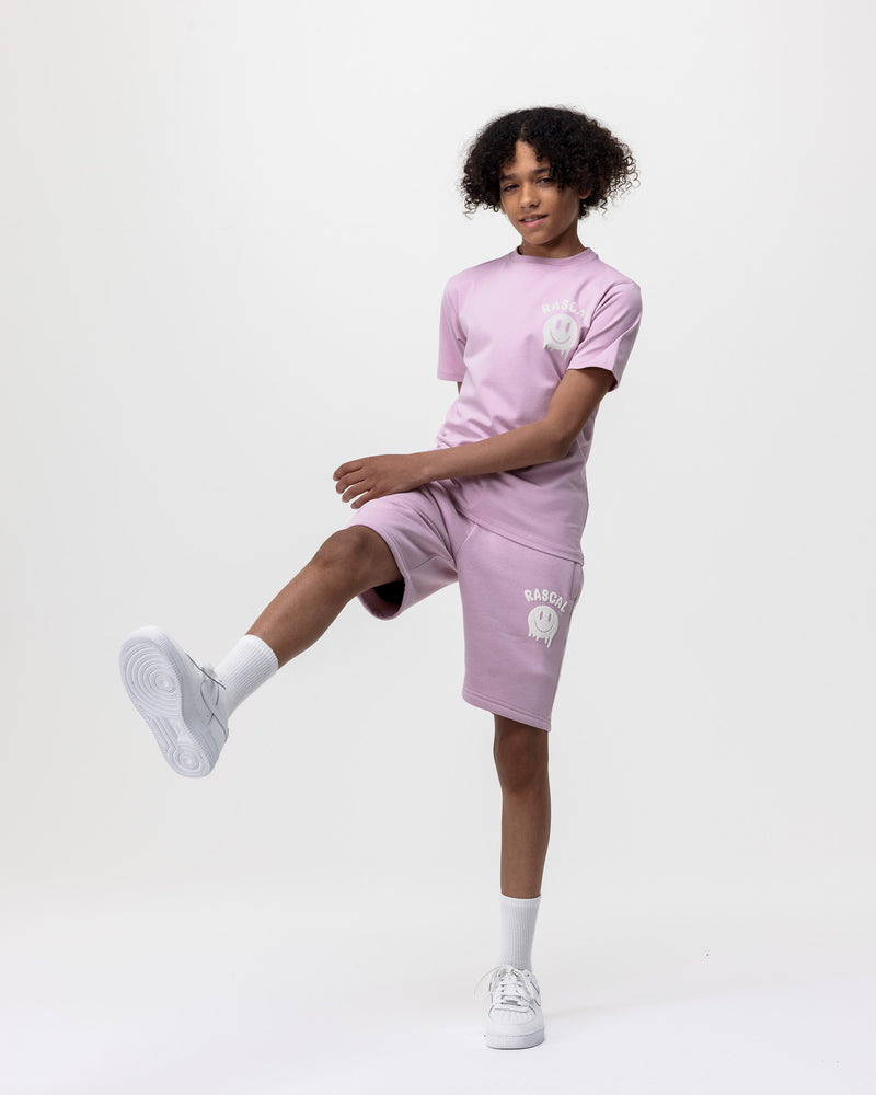 boy model wearing Rascal pink jogger smiley face shorts and pink smiley tee