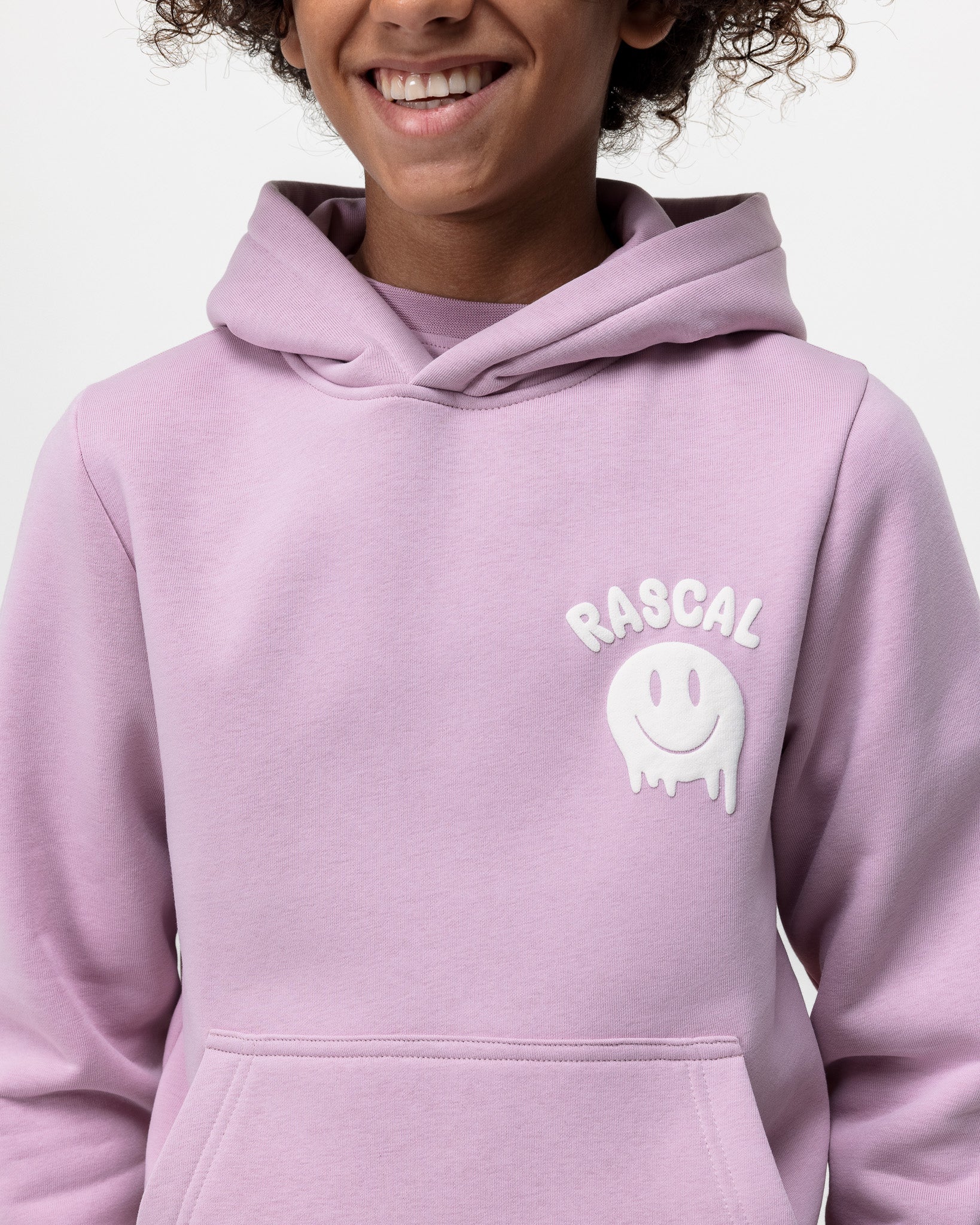 close up of boy wearing pink smiley hoodie