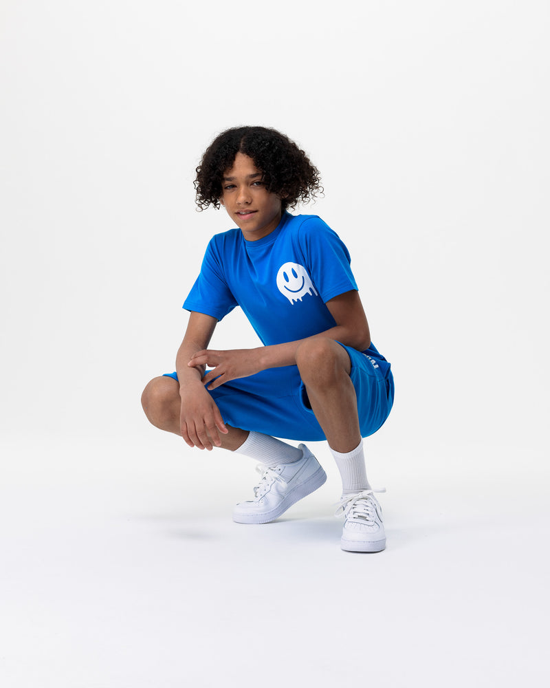 boy crouching wearing Rascal blue shorts and blue smiley tshirt with white smiley face graphics 